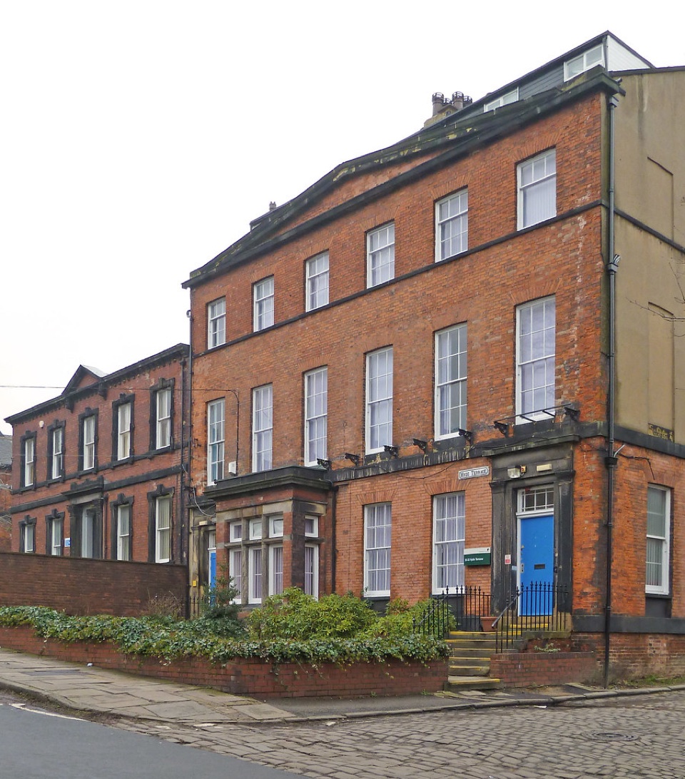 The corner of a red brick terrace on Hyde Terrace in Leeds, showing the blank side wall